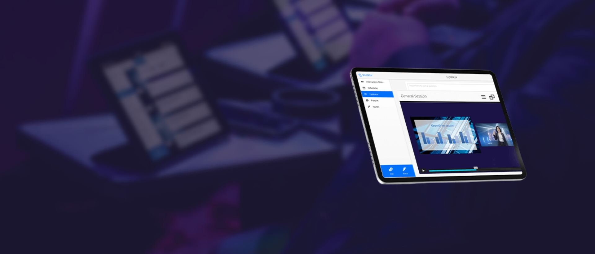 A tablet screen displays a digital presentation with charts and a speaker, while blurred tablets and hands are visible in the background. The scene suggests a tech or business meeting.